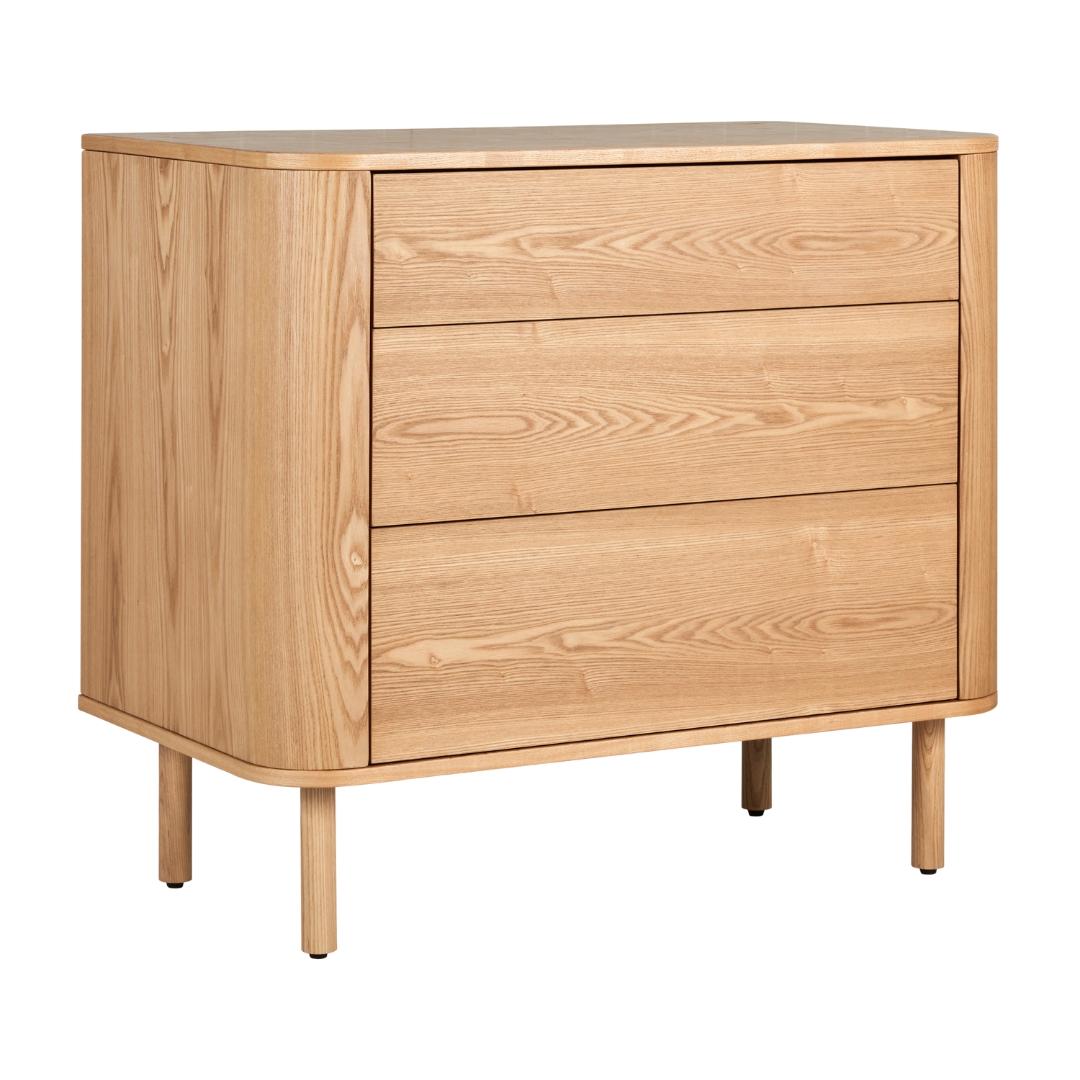 A natural ash wood chest with three drawers, featuring a soft, rounded design and a warm wood finish.