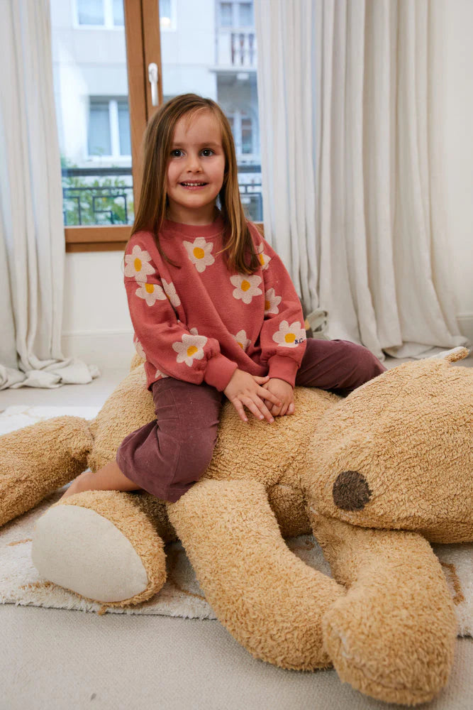 A plush toy resembling a sleepy bear with soft fur in honey-coloured tones, featuring a zipper on its bottom for removing the inner filler, kids bean bags and poufs Singapore, lorena canals singapore