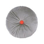 A round cushion with a slate grey color and a central orange button, from the Nobodinoz, Eco-Velvet collection, available in Singapore