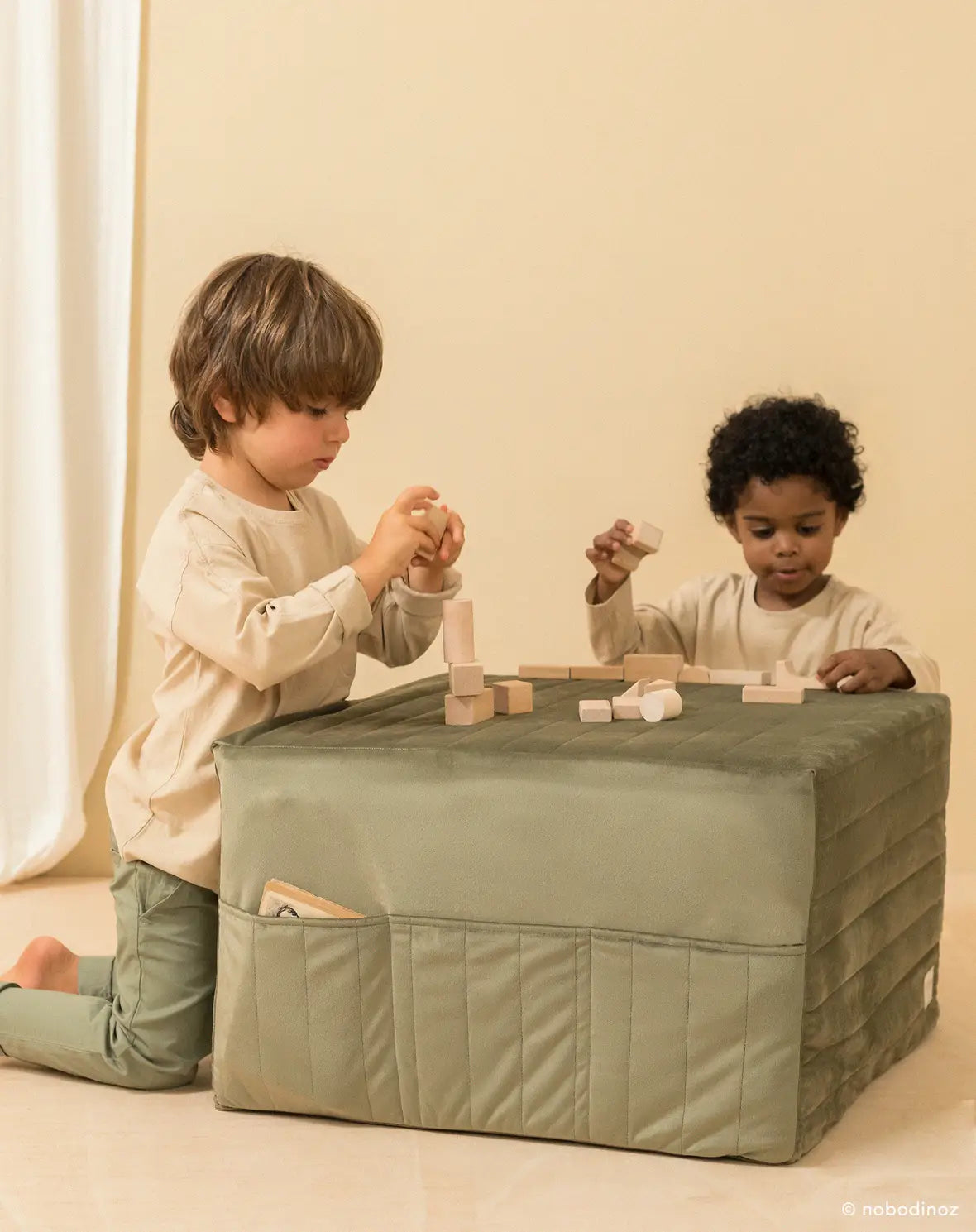A sleepover mattress bean bag in olive green and a folded beige mattress, both made of eco-velvet. convertible mattress to pouf, kids bean bags and poufs Singapore