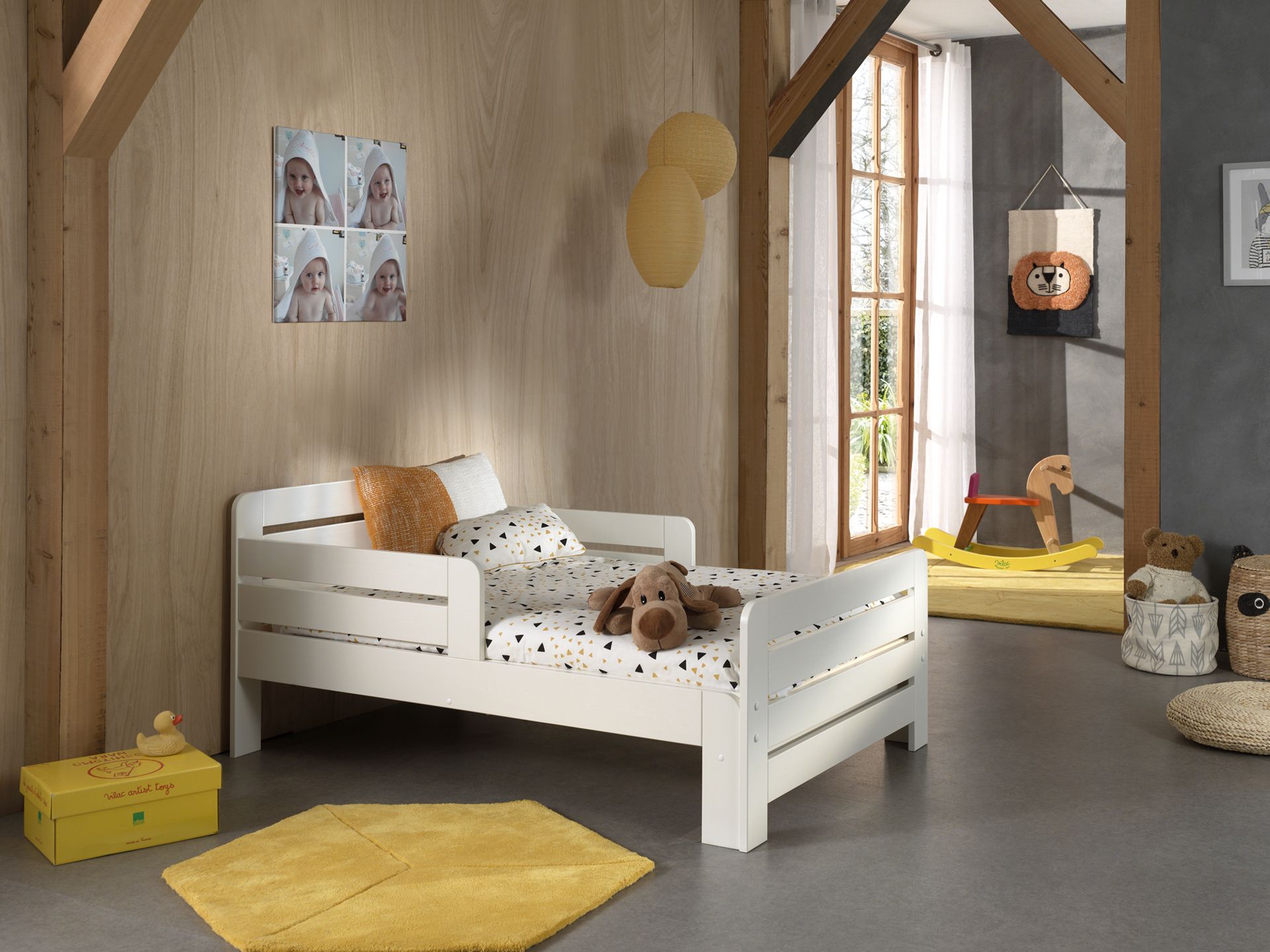 A white transformable bed with a mattress, designed to adjust in length. Available in Singapore, kids bed singapore, kids toddler bed singapore