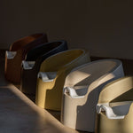 A beige Quax potty with a white inner bowl and high backrest, designed for toddlers.