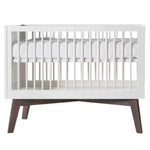 Deer Industries Baby Bed Nursery furniture Sixties matte white in combination with a dark wooden base. Cot and cot bed with standard European mattress size 60x120 or 70x140. Made in Europe complies with all European safety regulations. Stylish baby crib contemporary but a bit retro. Gender neutral for baby boy and baby girl and for toddler as the beds are convertible in both sizes.